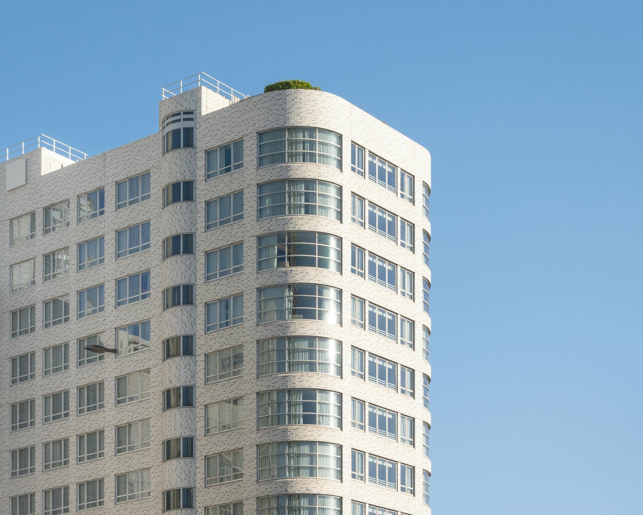 A contemporary building in Hong Kong against a clear blue sky, showcasing urban architecture.