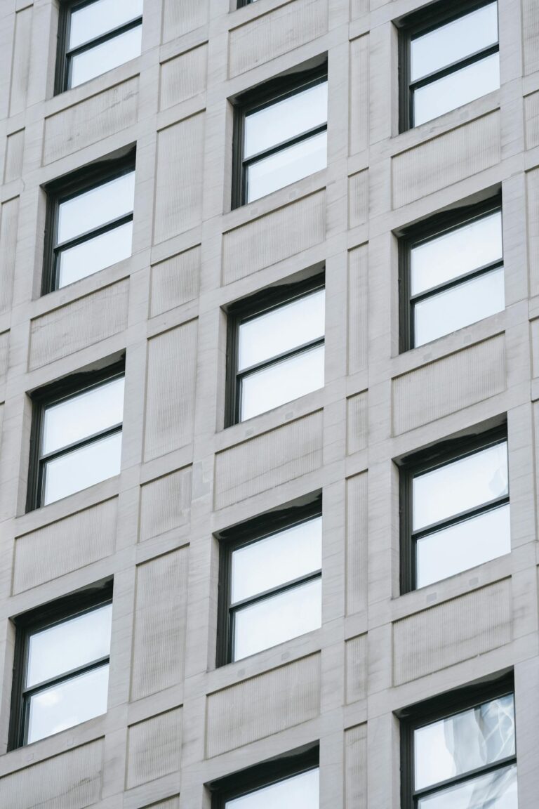 High-angle view of a modern building facade with reflective windows showcasing clean architecture.