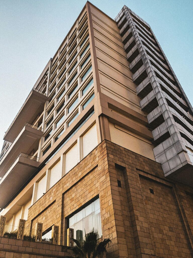 Low-angle view of a modern high-rise building in an urban setting, showcasing contemporary architecture.
