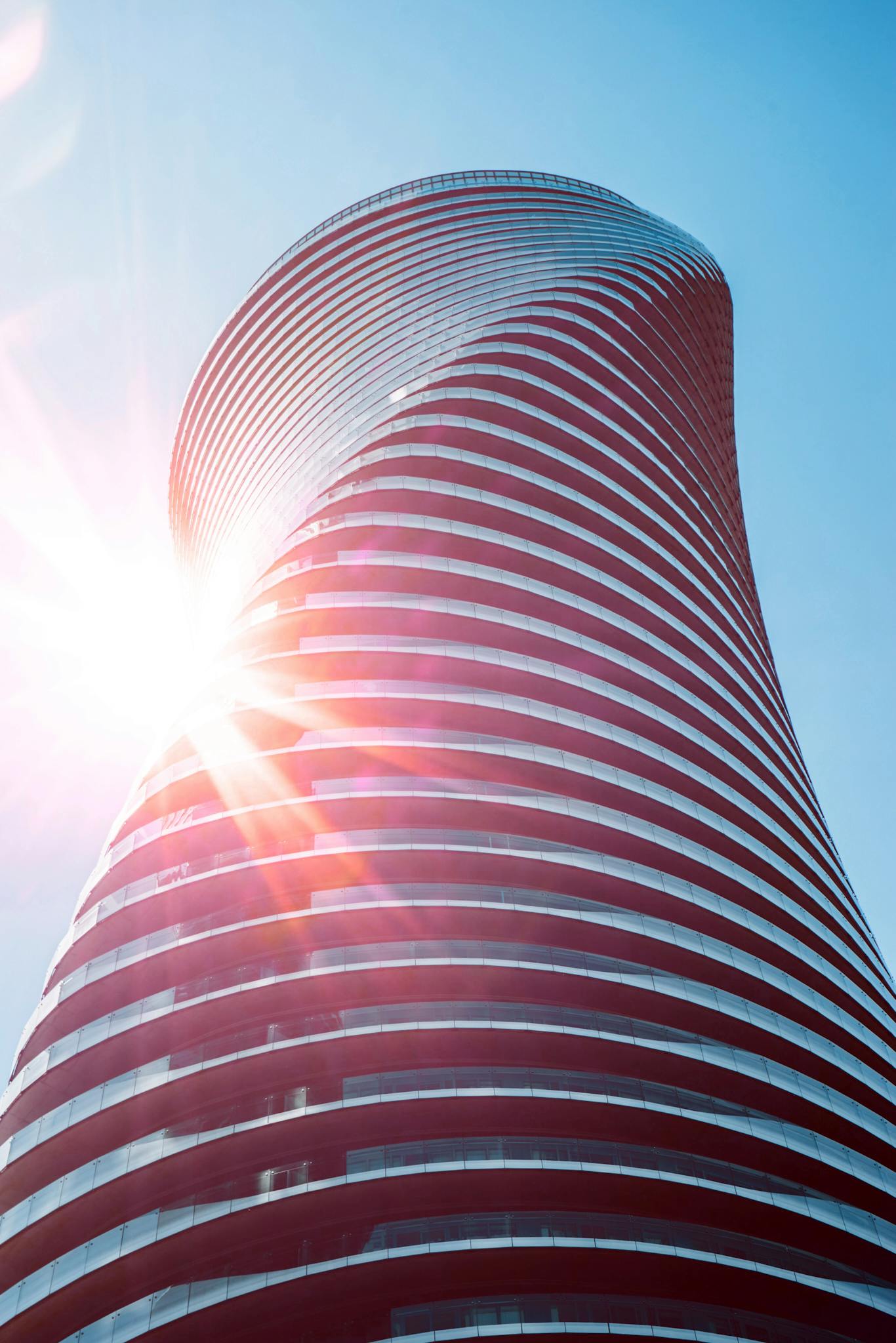 Stunning low angle shot of modern skyscraper with sun flare, Mississauga.